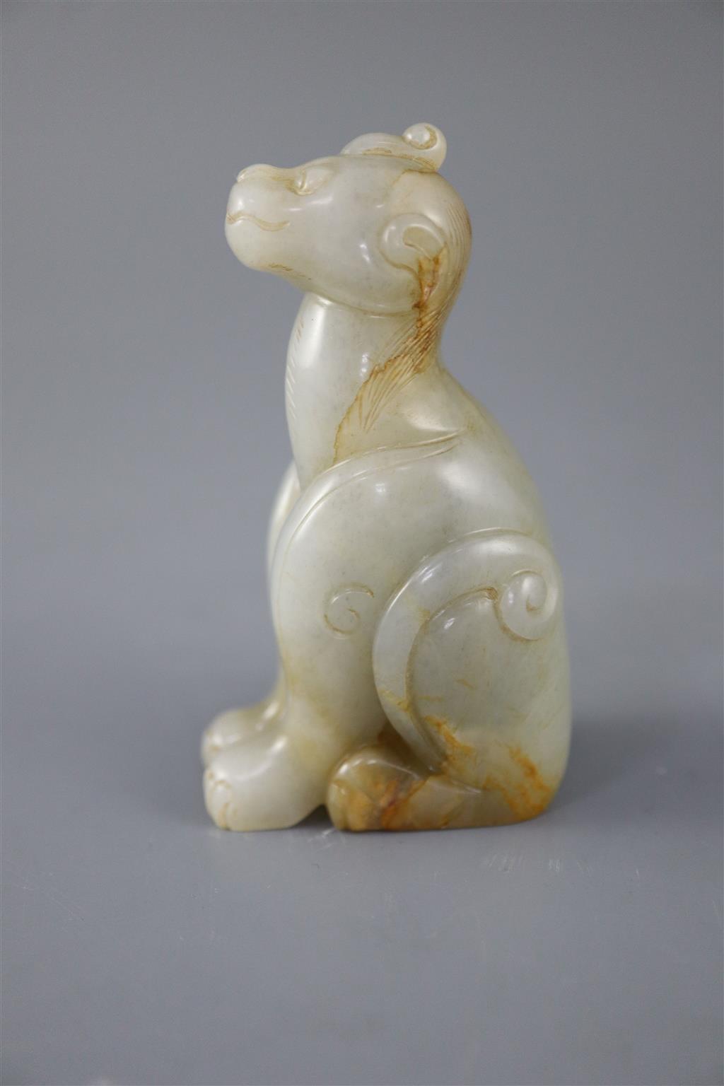 A Chinese pale celadon and russet jade figure of a mythical beast, 7.5cm high